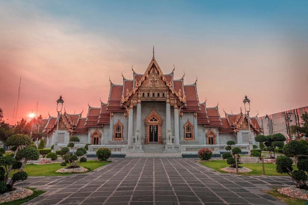 Wat Benchamabophit - The Marble Temple with sun setting in the background