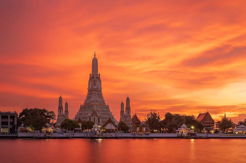 wat arun against bright red and orange sunset